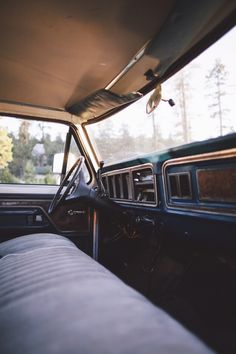 the interior of an old pickup truck with its sunroof open and it's passenger seat down