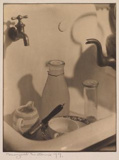 an old fashioned bathroom sink with soap, toothbrushes and other items in it