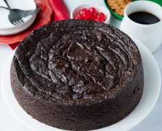 a chocolate cake sitting on top of a white plate