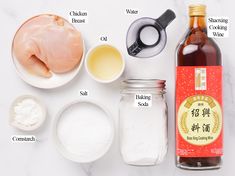 ingredients needed to make chicken broth laid out on a white counter top with labels