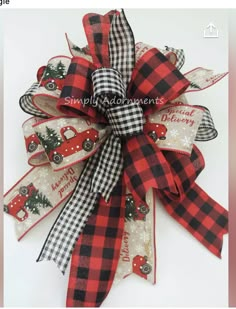 a red and black buffalo plaid christmas tree bow with cars on it, the ribbon is attached