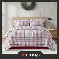 a plaid comforter set with christmas wreath on the wall