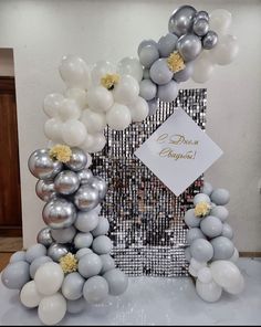 a silver and white photo frame with balloons