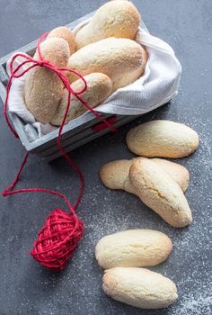 some cookies are sitting on a table next to a red string and a white bag