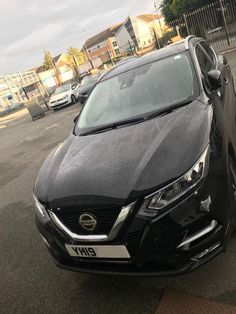 a black car parked on the side of a road