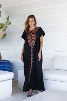 A bohemian flash caftan made of light mesh of linen and poly, the fabric is unique in that it's very flowy and not the usual feel and touch of linen. This Kaftan is ideal to wear for any casual occasion. Whether taking a trip down the shopping lane, or home-based kitty parties, or about anything else, wearing this dress will make you feel classy and comfortable. Fabric : 50% Linen, 50% Polyester. Please note that the fabric on this Kaftan has some weight to it and is meant to give off that crumb Traditional Maxi Dress With Multicolor Embroidery, Traditional Multicolor Embroidered Maxi Dress, Black Abaya With Floral Embroidery, Traditional Long Black Kaftan, Traditional Black Maxi Length Thobe, Black Bohemian Tunic For Spring, Black Embroidered Maxi Dress For Eid, Black Floor-length Maxi Dress For Festival, Traditional Black Kaftan With Floral Embroidery