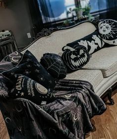 a couch covered in black and white pillows