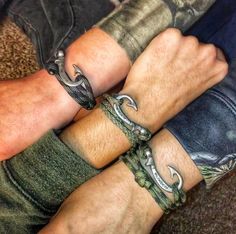 two men with bracelets on their hands