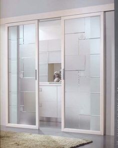 an open sliding glass door in a room with carpet on the floor and wall behind it