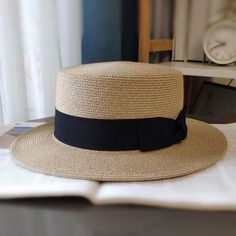 Stay cool and stylish with our classic straw boater hat. Crafted from high-quality, breathable straw, it features a wide brim for excellent sun protection and a chic black ribbon band. The lightweight design ensures comfort, making it perfect for garden parties, beach outings, and casual strolls. Elevate your look with this elegant and functional accessory. Size: M: 56-58cm & L: 58-60cmStyle: CasualBrim Style: Wide brimCrown Design: Round crownShape: FlatDesign Details: Bowknot Casual Straw Hat With Flat Crown, Elegant Straw Hat With Flat Crown For Beach, Classic Brimmed Boater Hat For Beach, Casual Straw Hat With Flat Crown For Vacation, Classic Straw Hat With Flat Crown For Beach, Classic Straw Boater Hat For Vacation, Summer Fedora With Flat Crown For The Beach, Summer Fedora With Flat Crown For Beach, Black Summer Hat With Flat Crown