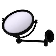 a black magnifying mirror mounted on a wall next to a light bulb and plugged in