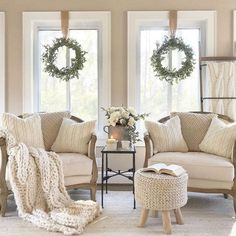 the living room is decorated with wreaths and pillows