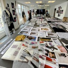 a long table covered in pictures and papers