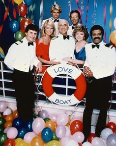 a group of people standing in front of balloons