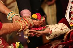 the bride and groom are holding their hands together