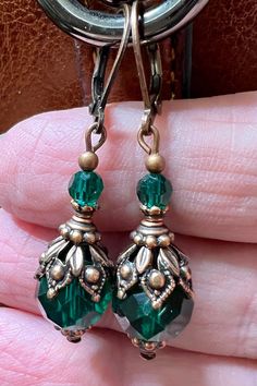 Emerald green or Black earrings with vintage antiqued style copper bead caps. All orders come in a gift box. The largest bead is 10 mm in diameter. The earrings are approximately 1.5 inches long. Blue Pearl Earrings, Victorian Style Earrings, Red Bead Earrings, Jewelry Emerald, Vintage Inspired Earrings, Romantic Earrings, Jewelry Making Earrings, Vintage Style Earrings, Purple Jewelry