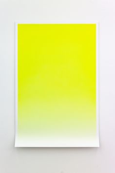 a yellow and green painting on a white wall