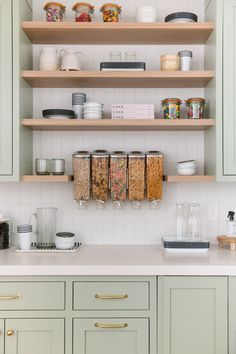 the shelves in the kitchen are filled with food