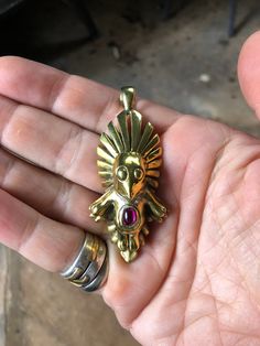 "This item is an empowerment charm, to be worn around the neck, hung from a rearview mirror, as a keychain, or any other apparent option. It is a reminder of our innate godliness, of our resilience, and our power to create our own reality. It signifies what the viewer sees in it, and reflects that back to the seer tenfold. Behold your own inner beauty, and steep yourself in the power of this charm's radiance. The imagery of the QuetzalMini is rooted in the various forms of the Garuda, the interd Unique Pendant Jewelry For Rituals, Unique Good Luck Pendant Jewelry, Red Spiritual Brass Jewelry, Ceremonial Hand Cast Amulet Jewelry, Ceremonial Hand Cast Jewelry Pendant, Ceremonial Hand Forged Pendant Jewelry, Feathered Serpent, Ancient Aztecs, Red Agate