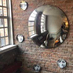 there is a mirror on the brick wall