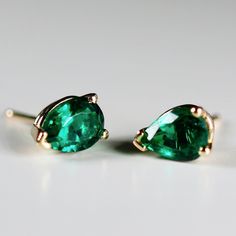 Elevate your style with our 14k Gold Pear Cut Emerald Stud Earrings, perfect for adding a touch of sophistication and elegance to any outfit. These pear cut emerald stud earrings are the perfect size for everyday wear or special occasions, and their brilliant green color is sure to catch the eye and make a statement. These exquisite studs feature genuine emerald gemstones that are lab-grown for a sustainable and ethical choice. Unlike simulated or CZ stones, lab-grown emeralds are identical in c Emerald Pear-shaped Fine Jewelry Earrings, Classic Emerald Pear-shaped Earrings, Classic Pear-shaped Emerald Earrings, Timeless Green Earrings As A Gift, Timeless Green Earrings For Gift, Classic Pear-shaped May Birthstone Earrings, Classic Green Pear Shaped Earrings, Classic Green Pear-shaped Earrings, Emerald Stud Earrings