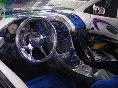 the interior of a car is decorated with blue and white stripes on it's dash board