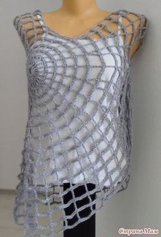 a mannequin wearing a white top with silver net on it's shoulders