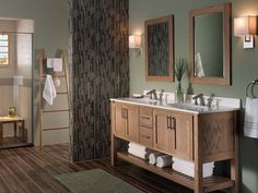 a bathroom with two sinks and mirrors on the wall