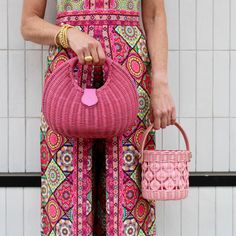 Add a pop of color to your summer accessories collection with this fun and fabulous bag! This chic wicker bucket bag features a leather handle and removable crossbody strap. Product Overview: Materials: wicker, cotton, lambskin, gold hardware Size: 6’’ H (4’’ handle drop) x 5.5’’ W Chic Woven Leather Straw Bag With Top Handle, Summer Woven Leather Bag With Round Handle, Summer Straw Bag With Woven Leather And Round Handle, Pink Bucket Bag With Braided Handles And Top Handle, Chic Straw Bag With Woven Leather And Round Handle, Spring Woven Leather Top Handle Bag, Spring Top Handle Bag In Woven Leather, Chic Straw Bag With Round Leather Handles, Chic Shoulder Bag With Bamboo Handle