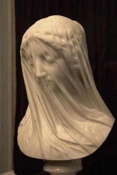 a white busturine with a veil on it's head