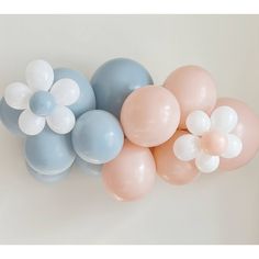 several balloons with flowers on them are arranged in a horizontal arrangement against a white wall