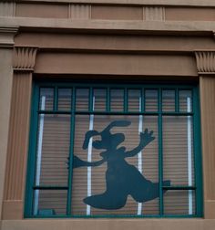 the shadow of a person in a window with bars on it's windowsill