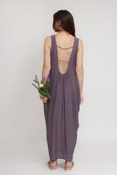 Brand: Mod Ref Open back maxi dress with exaggerated draping on both sides. ♡ Details Color: Purple Draping sides, slightly tapered towards bottom Open back Lined 96% Rayon, 4% Spandex Hand wash Sizing Model Info: Height 5'3"| Bust 32"| Waist 25"| Hips 34" Model is wearing a size medium Fit: Relaxed fit Stretch: More stretch MEASUREMENTS: S: Bust = 33" | Length = 49.5" M: Bust = 35" | Length = 50" L: Bust = 37" | Length = 51" Summer Stretch Dress With Cowl Back, Stretch Maxi Dress With Low Back, Stretch Maxi Dress With Tie Back, Spring Backless Dress With Ruched Cowl Back, Spring Backless Ruched Cowl Back Dress, Spring Maxi Dress With Ruched Back, Stretch Backless Maxi Dress With Tie Back, Stretch Maxi Dress With Low Back For Summer, Summer Evening Maxi Dress With Cowl Back