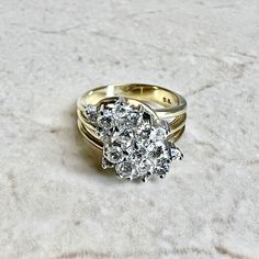 CLEARANCE - 40% OFF! A magnificent and fine vintage diamond cluster cocktail ring crafted in 14 karat yellow and white gold. Circa 1970. It is set with 19 round diamonds weighing approximately 1.35 CTTW.The stones are approximately G-H color, SI clarity. Stamped 14K. Weighs 8.5 grams. Size 6.75 US / N UK. > Ring sizing not included.This ring can be sized to fit most fingers.If you need to size this ring, please contact us before placing the order.Sized rings are final sale. Our minimum sizing fe Timeless Diamond Cluster Ring With 17 Jewels, Classic Vvs Clarity Cluster Ring, Anniversary Diamond White Cluster Ring, Heirloom White Gold Cluster Diamond Ring, Heirloom White Diamond Cluster Ring, Antique Cluster Diamond Ring With Accents, Vintage White Cluster Diamond Ring, Heirloom Cluster Diamond Ring In White Gold, Collectible Cluster Diamond Rings