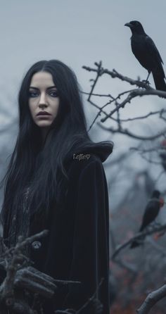 a woman with long black hair standing in front of a crow on a tree branch