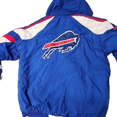 Storage unit find. NWT. Good elastic. A bit dusty. Excellent condition for its age. A few stray threads. Removable hood included. See photos. Please ask any questions or for additional photos. This vintage Starter Pro Line Buffalo Bills jacket is a must-have for any true fan! With its blue polyester exterior and full zip closure, this XL puffer jacket is perfect for staying warm and stylish during the colder months. The jacket features a hood and is made with nylon lining material and polyester insulation material for extra warmth. In addition to its functional features, this jacket also has a stylish 90s theme and is brand new with tags. It is perfect for adding a touch of nostalgia to any outfit. Don't miss out on the chance to own this rare piece of NFL memorabilia. Buffalo Bills, Buffalo, Hooded Jacket, Stay Warm, Vest Jacket, Nfl, Coats Jackets, Mens Accessories, Brand New