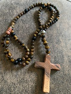 Very pretty Pellerin necklace With its handmade olive wood cross pendant Composed of tiger's eye stones And a Swarovski skull As well as obsidian stones Delicately packaged Olive Wood Cross, Wood Cross, Obsidian Stone, Tiger Eye Stone, Tiger's Eye, Olive Wood, Cross Pendant, Pendant Necklaces, Halloween Shopping