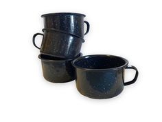 three black coffee mugs sitting next to each other on a white surface with space in between them