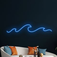 a living room filled with furniture and a neon blue wave wall decal on the wall