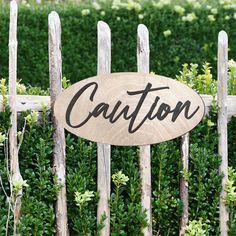 a wooden sign that says private parking in front of a fence with bushes behind it