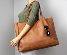 "Soft, flexible camel grain leather tote bag for books or for summer weekends. A large, camel leather bag can be easily taken to the beach. This wonderful bag has a lot of space. This is a really, really big bag. Front of bag features an exterior pocket for quick-access to your keys or phone. Large interior pocket measures approximately 15\" wide by 12\" long Wery useful , gorgeous everyday bag for all seasons! Height: 39 cm / 15.4\" Max width at the top: 61 cm / 24\" Width at the base: 51 cm / Dark Tan Travel Shoulder Bag, Casual Shoulder Bag With Smooth Grain For Travel, Camel Shoulder Bag Large Capacity For Travel, Camel Tote Shoulder Bag For Travel, Camel Tote Satchel For Travel, Brown Shoulder Bag With Luggage Sleeve For Shopping, Dark Tan Tote Shoulder Bag For Travel, Large Capacity Camel Tote Satchel, Camel Travel Tote Satchel