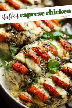 grilled chicken with tomatoes and spinach in a white dish on a wooden table