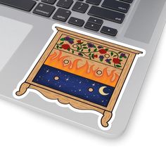 a laptop computer with an ornate sticker on the keyboard and it's screen