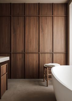 a bath tub sitting next to a wooden wall