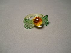 a ring with a flower on it sitting on a table