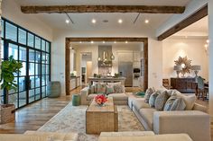 a living room filled with furniture and lots of windows