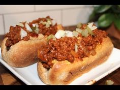 two chili dogs are sitting on a plate