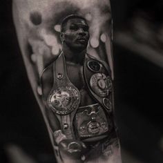 a black and white photo of a man's arm with boxing gloves on it