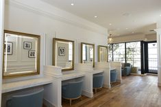 a row of white counter tops sitting next to each other on top of a hard wood floor