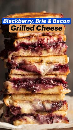 stack of grilled cheese sandwiches with blackberry brie and bacon toppings on top